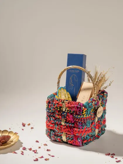 A colorful woven basket from Doro, styled as a gift hamper. This shot showcases the basket's versatility as a beautiful and functional packaging option.