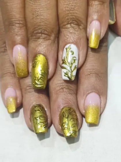 A close-up of the golden bridal set, focusing on the detailed 3D floral patterns and the smooth gold chrome finish. Each nail is a piece of art designed for your most important day.