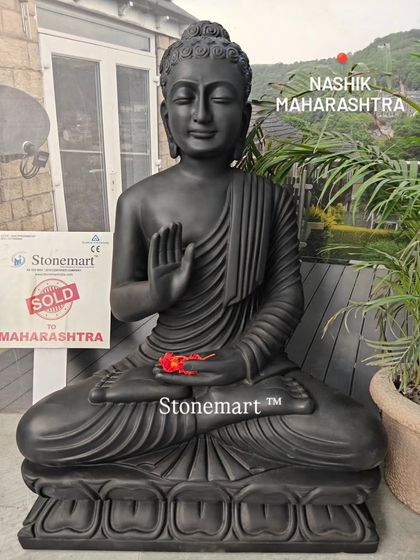 A full-length view of the 3-foot black marble Buddha, showing the detailed carving on the lotus base and the graceful flow of the robes.