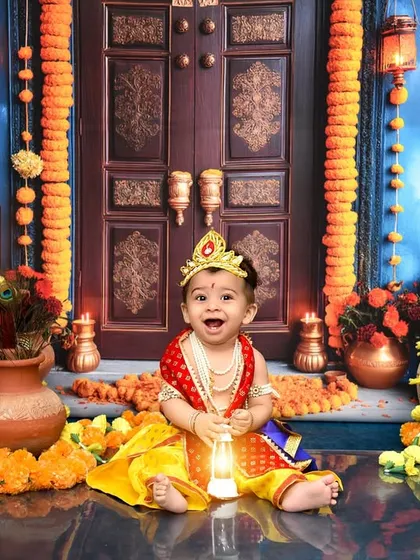 I create elaborate, culturally rich setups like this beautiful Krishna theme for Janmashtami. Every detail, from the lighting and marigolds to the traditional attire, is carefully planned to create a divine and memorable portrait.