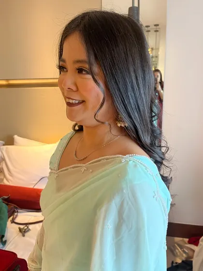 She was all smiles! The soft curls and glowing makeup made her feel comfortable and ready to celebrate.