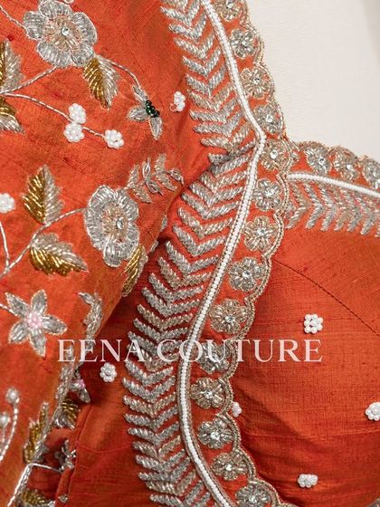 My signature Katori blouse in a festive burnt orange. This piece features contemporary silver and white floral embroidery on the sleeves, with delicate pearl detailing scattered across the body for a touch of bling.