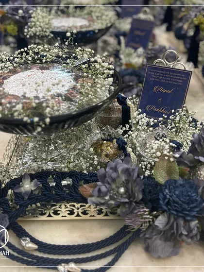 Another view of the Azure Crystal Bowl hamper with jars, surrounded by baby's breath and custom floral arrangements. The deep blue and silver combination exudes a sense of royal sophistication.