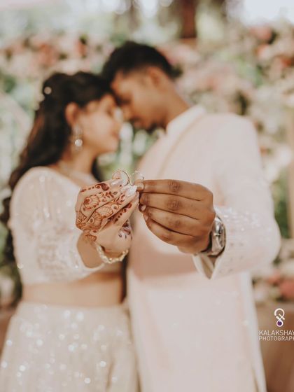 A creative shot focusing on the engagement rings, symbolizing the couple's union.