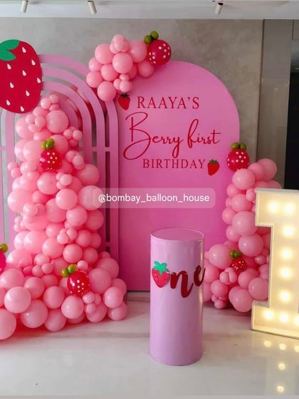 A sweet "Berry First Birthday" theme, using shades of pink to create a strawberry-inspired look with a large light-up number "1".