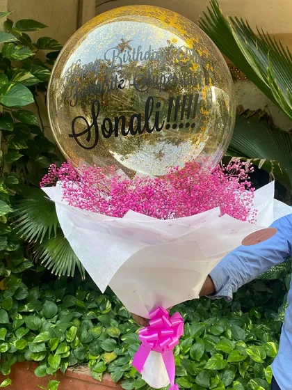 Simplicity can be so beautiful. This arrangement features a full bouquet of delicate pink baby's breath, paired with a personalized confetti-filled bubble balloon for a sweet and elegant birthday surprise.