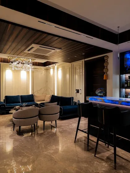 This wide shot shows the full living and bar area, demonstrating how I design open-plan spaces to have distinct zones while maintaining a cohesive look and feel.