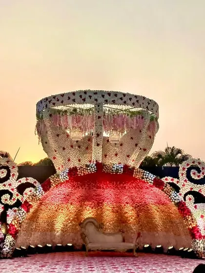This reception stage was a true showstopper, designed to look like a magnificent floral sculpture. The unique, multi-layered structure adorned with thousands of flowers created an unforgettable backdrop for the couple's celebration.