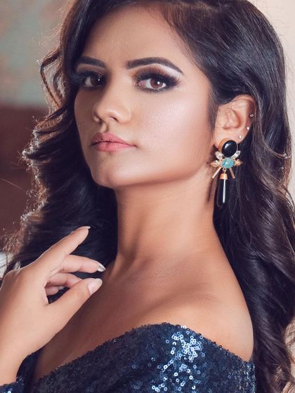 Minimal can be incredibly gorgeous. This look for a model features a sharp smokey eye, defined brows, and a neutral lip, creating a powerful and modern party look.