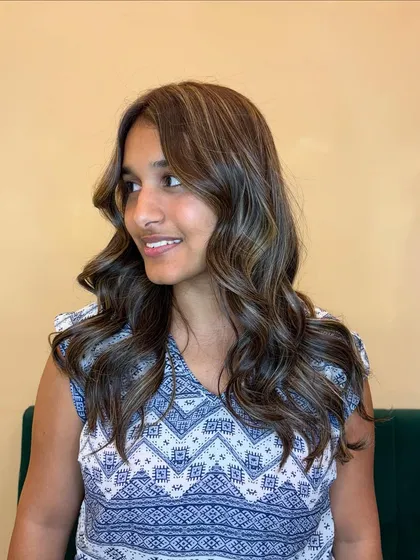The cool tones in this ash blonde balayage beautifully complement her skin, giving her a fresh and radiant appearance.
