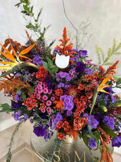 For the discerning lover of the bold, bright, and exotic. A symphony of deep pinks and dramatic oranges, this arrangement uses birds of paradise and amaranthus to create a design that is full of energy and life.
