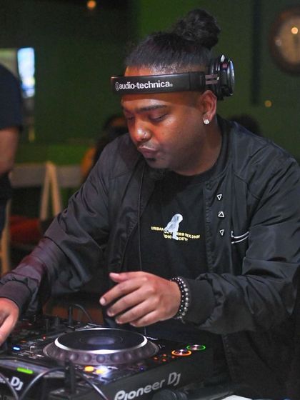 Focused on the mix at Jack's Bar. It's about blending tracks smoothly to keep the party's momentum going.