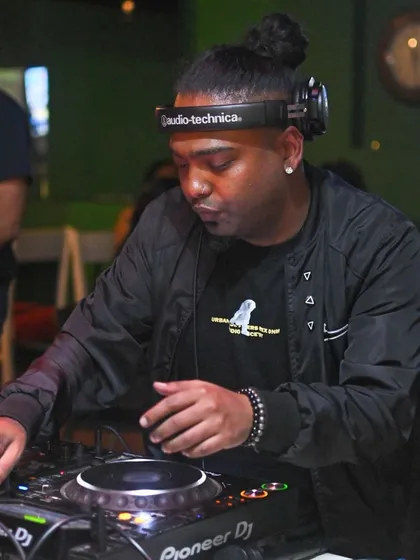 Focused on the mix at Jack's Bar. It's about blending tracks smoothly to keep the party's momentum going.