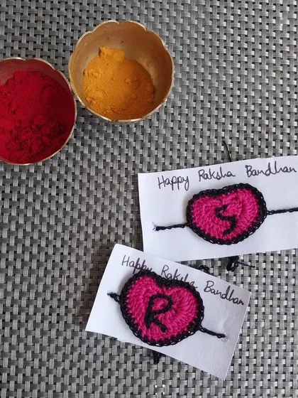 A personalized heart rakhi with initials. This is a sweet and simple way to show your love this Raksha Bandhan.