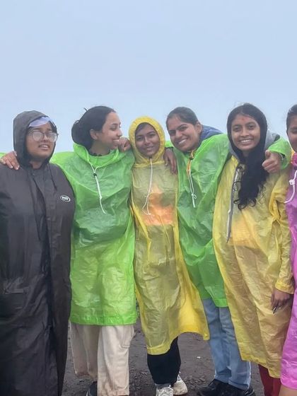 All smiles in our raincoats during a monsoon trip to Chikmagalur.