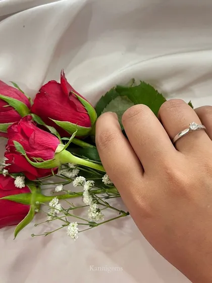 A simple solitaire diamond set in a silver-finish band. This ring offers a look of timeless grace, perfect for a promise that lasts forever.