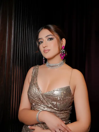 A beautiful portrait capturing the sultry essence of the evening glam. The winged eyeliner and soft contouring enhance her features, creating a look that is both sophisticated and modern.