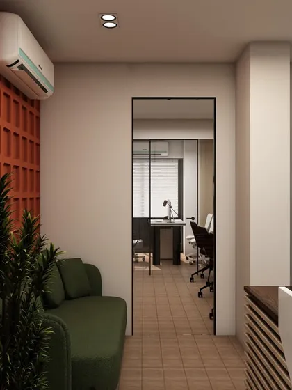 The waiting area adjacent to the 'A-ONE Engineering' reception. A comfortable sofa set against a textured accent wall provides a pleasant space for visitors.