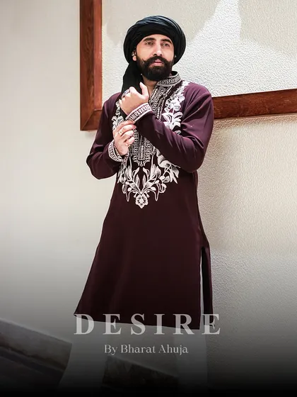 Adjusting a cuff, owning the moment. This pose captures the essence of my clothing: it is made to give you confidence in every gesture. The embroidery detail on the cuff is a mark of bespoke quality.