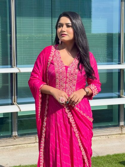 Another look at the elegant pink suit, perfect for the festive season. It's comfortable enough to move around and interact with guests for hours.