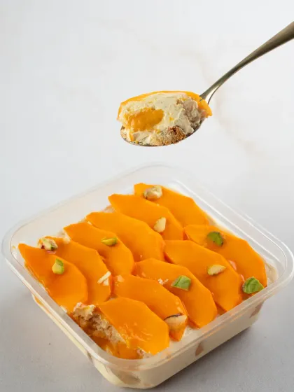 Our Mango Tres Leches dessert tub, with slices of fresh mango on top. It’s a light, refreshing, and satisfying treat.