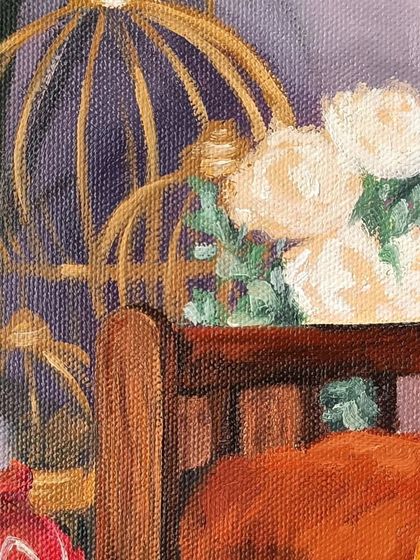 A close-up of the background details in the baby Kanha portrait, including the birdcage and flowers.