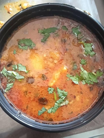 A bowl of my homestyle Aloo Sabzi, the perfect accompaniment for pooris or rotis. It's a simple potato curry cooked in a light tomato-based gravy.