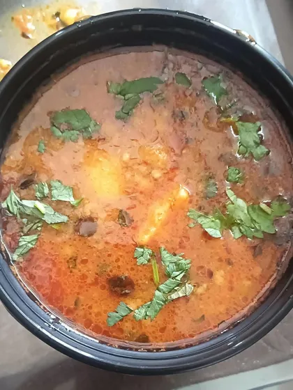 A simple bowl of Aloo ki Sabzi, made with a tomato-based gravy. This is the perfect accompaniment for pooris or rotis.
