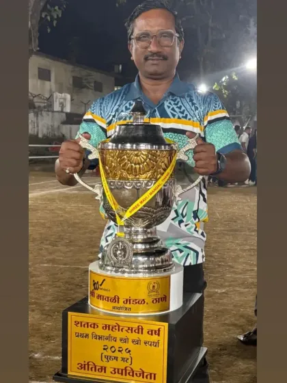 Our respected coach, Dr. Narendra V. Kunder, with a championship trophy. He is the architect of our success.