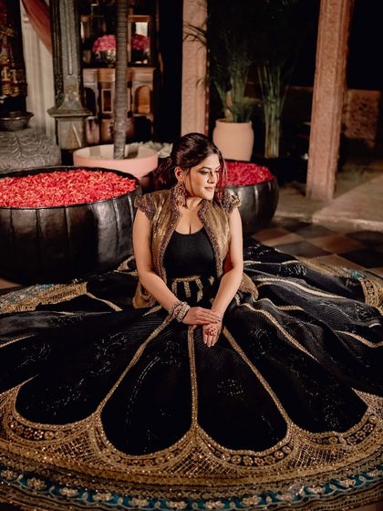 Seated amidst a regal setting, the intricate hand-embroidery and rich fabrics of this heritage-inspired lehenga tell a story of Marwar's legacy, reimagined for the modern connoisseur.