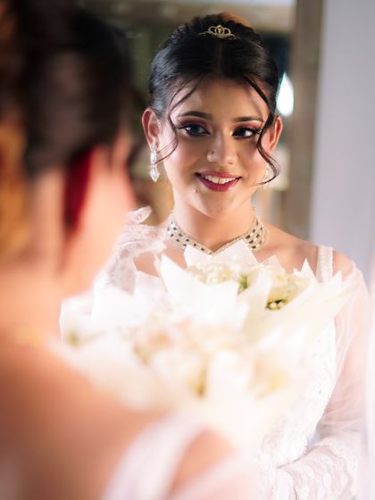 A soft and romantic Christian bride look, featuring a white gown, delicate jewelry, and a fresh, glowing makeup style.