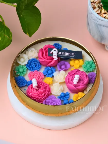 Another view of the technicolor urli, showcasing a different arrangement of bright and beautiful wax flowers.