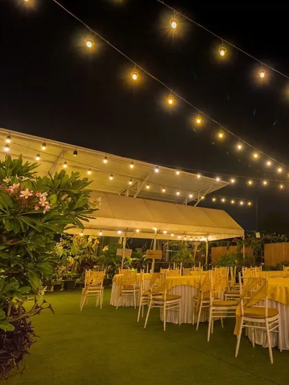 The warm glow of string lights creates an inviting atmosphere for an evening event at our rooftop venue.