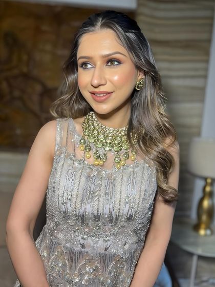 A side profile showing the beautiful soft waves and the glowing makeup.