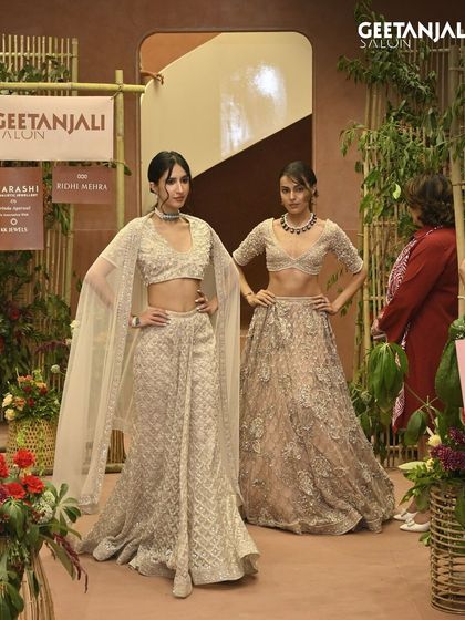 Two models posing in stunning bridal wear, their hair and makeup perfectly done by my team for the launch.
