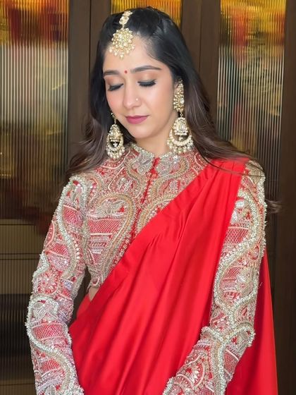 Karwachauth glam in a stunning red Anamika Khanna saree. The makeup is classic and elegant, with defined eyes and a soft lip, letting the intricate outfit and jewelry shine.