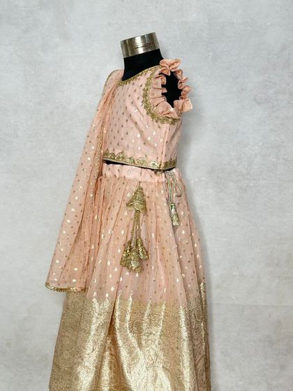 A side profile of the periwinkle lehenga, showcasing the ruffled neckline and the lightweight dupatta.