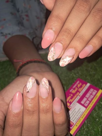 A soft and elegant design with a pink base and a delicate marble effect on the accent nails.