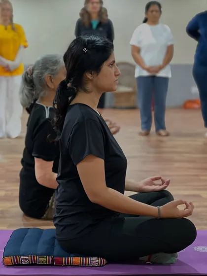 A student demonstrates a steady and comfortable posture during a meditation and pranayama session. Maintaining an erect spine is key for deep breathing and allowing the upward flow of prana, or life force energy.