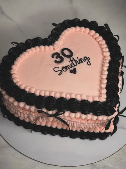 When you're entering a scary new decade, make sure you do it with one of my cakes to take the edge off. This "30 Something" heart-shaped cake has a cool black and pink design with delicate ribbon details.