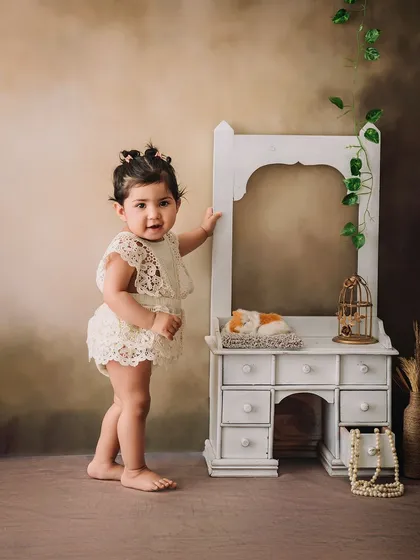 Standing tall and proud, this little girl shows off her new skills in a lovely, rustic-themed milestone portrait.