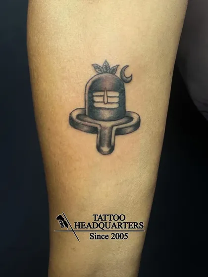 A minimalist Shiva Linga tattoo, shaded to give it a three-dimensional appearance, symbolizing divine energy.