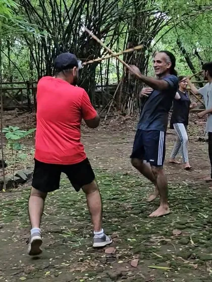Training isn't confined to four walls. Here in the forest, we practice stick fighting drills, learning to use our environment and stay aware. This is what I mean by being ready for anything, anywhere.