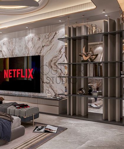 This view of the master suite showcases the integrated media wall, featuring a book-matched marble panel and a contemporary open shelving unit that doubles as a stylish room divider.