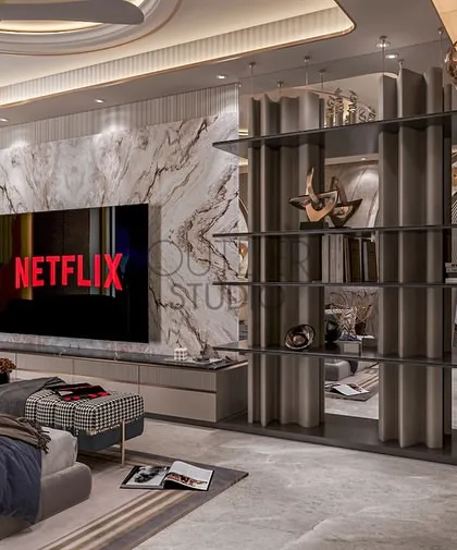 This view of the master suite showcases the integrated media wall, featuring a book-matched marble panel and a contemporary open shelving unit that doubles as a stylish room divider.