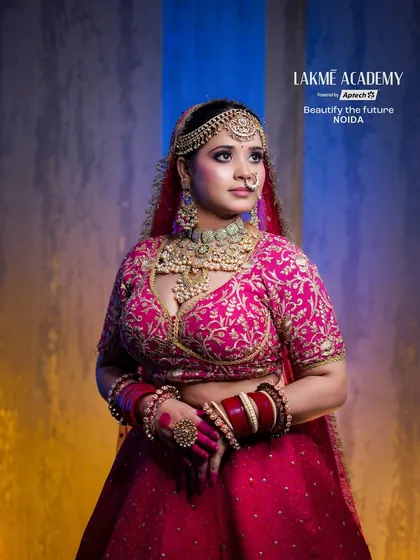 A full-length view of a radiant bride in a pink lehenga. This image showcases the ability to create a cohesive look where the makeup, outfit, and jewelry complement each other perfectly.