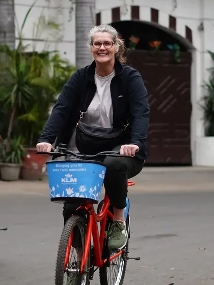 A happy rider pedals through a quiet neighborhood. Our tours are paced to be enjoyable for cyclists of all levels.