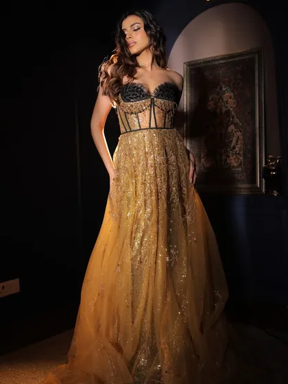 A dramatic full-length shot. The makeup is designed to complement this show-stopping gown, creating a cohesive and glamorous look for a reception or cocktail party.