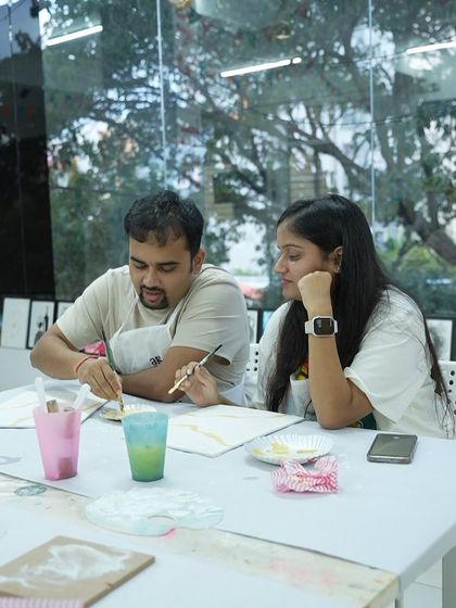 A couple works together on a painting during a workshop. Art is a wonderful way to connect and collaborate.