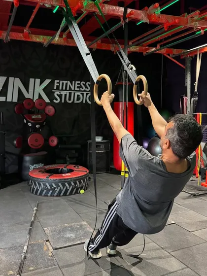 The TRX rings are an incredible tool for building upper body and core strength. This client is performing an inverted row, using his own bodyweight as resistance to work his back and biceps.